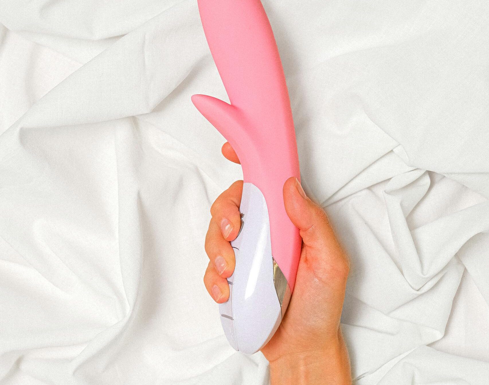 Person Holding a Pink Vibrator